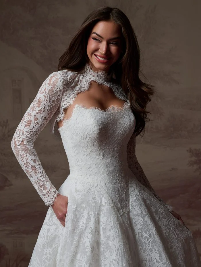Close-up of Serena by Maggie Sottero featuring delicate Chantilly lace, a structured bodice, and a deep square basque waist.