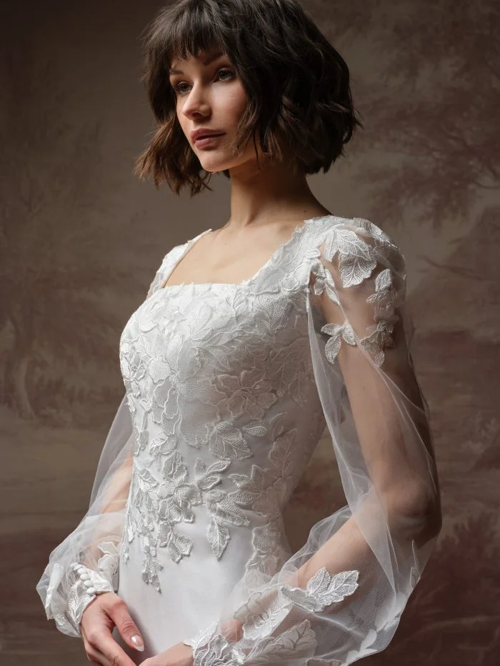 Close-up of Goldie Leigh by Rebecca Ingram featuring delicate floral lace motifs and a modest square neckline.