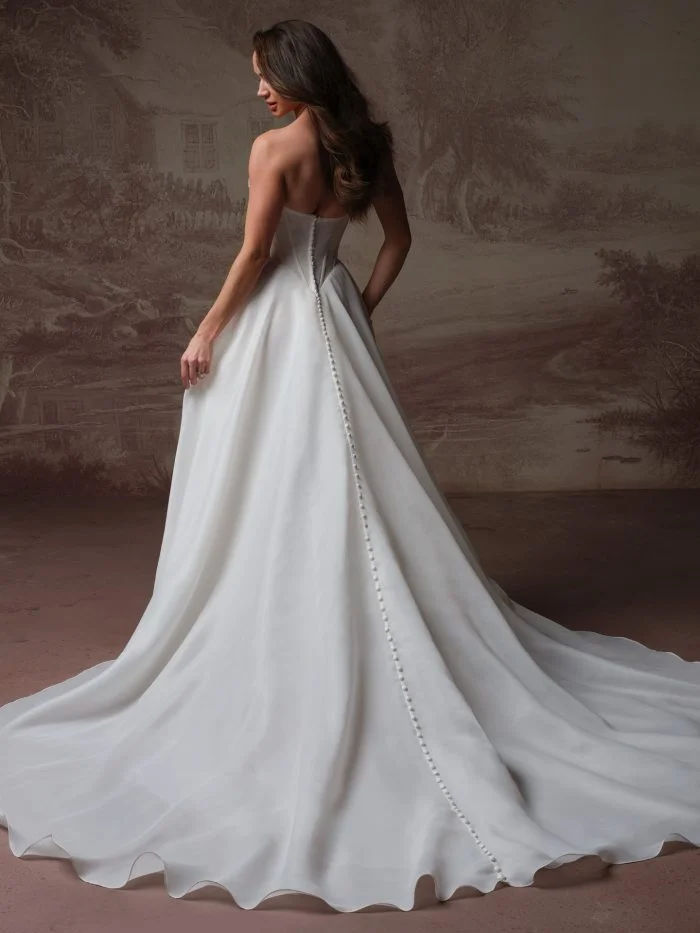 Back view of Abilene by Maggie Sottero showcasing covered buttons trailing down the organza A-line wedding dress.