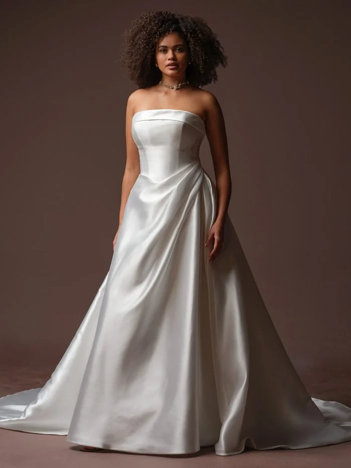 Bride wearing Agatha by Rebecca Ingram, a classic Mikado A-line wedding gown with a structured bodice and flowing skirt.