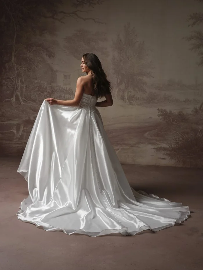 Back view of Rosamund by Maggie Sottero showcasing covered buttons trailing down a voluminous skirt.