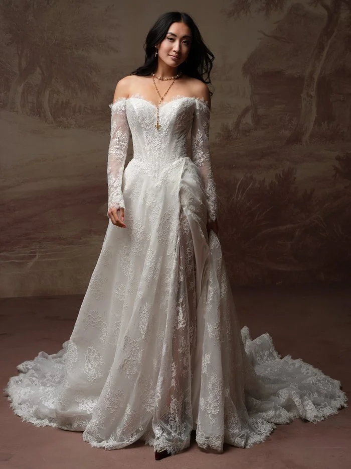 Bride wearing Vespera by Sottero and Midgley, a romantic allover lace wedding gown with a dramatic thigh-high slit.