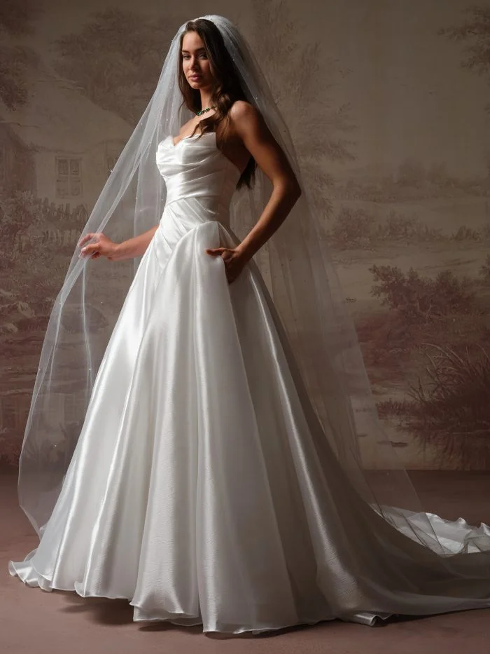 Bride wearing Rosamund by Maggie Sottero, a dramatic organza ballgown wedding dress with a full skirt and draped bodice.