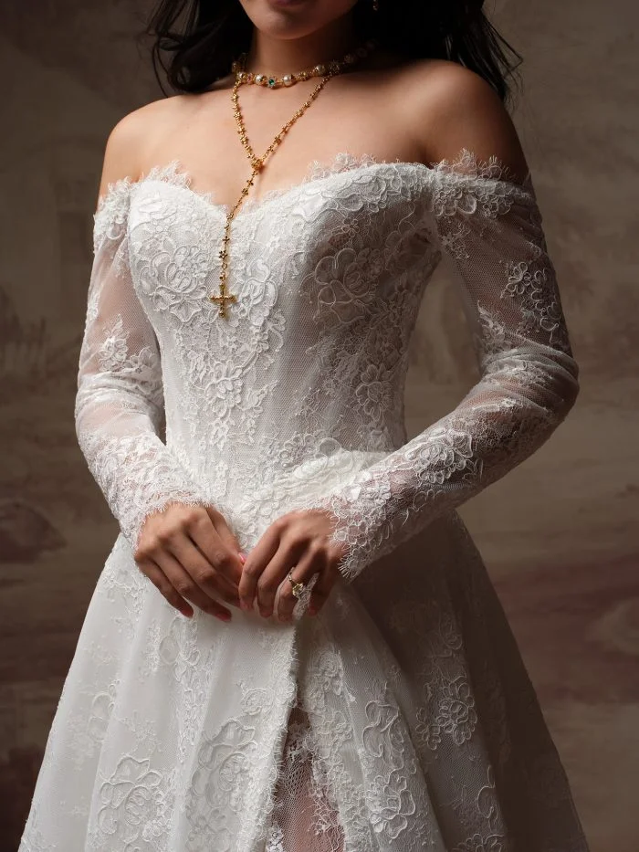 Close-up of Vespera by Sottero and Midgley featuring a lace corset bodice, exposed boning, and romantic basque waist.