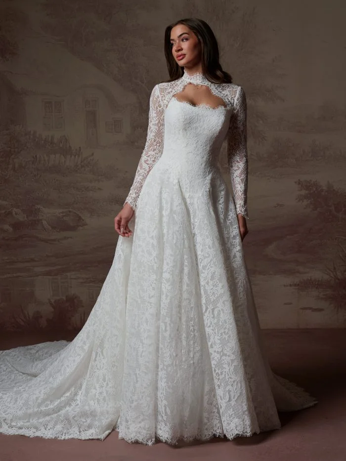 Serena by Maggie Sottero, a vintage-inspired Chantilly lace wedding dress with a sculpted basque waist and romantic ballgown skirt.