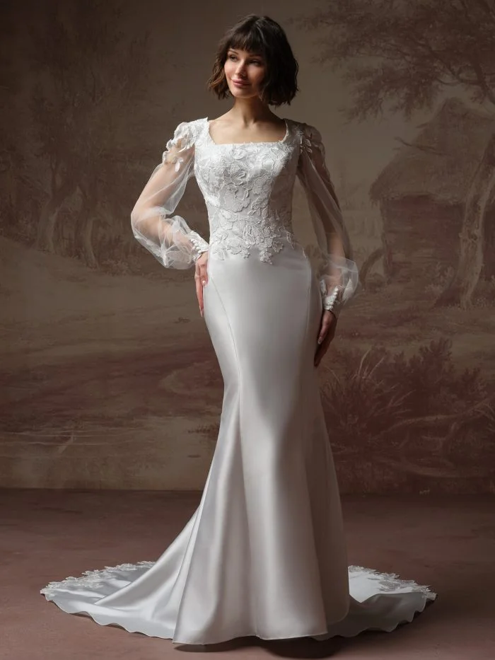Bride wearing Goldie Leigh by Rebecca Ingram, a romantic Mikado wedding gown with floral lace and long bishop sleeves.