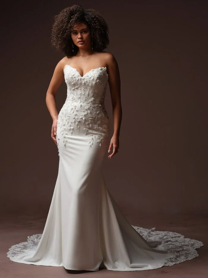 Bride wearing Blair by Sottero and Midgley, a romantic stretch crepe wedding gown with dimensional floral lace embellishments.