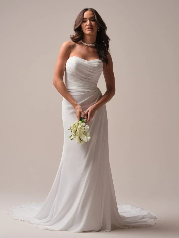 Francesca by Rebecca Ingram, a strapless chiffon sheath wedding dress with a soft scoop neckline and flowing skirt.