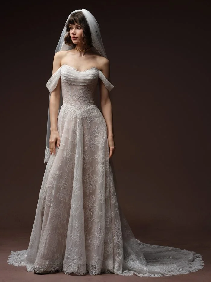 Maggie Sottero Maelle A-line wedding gown featuring allover lace, an off-the-shoulder neckline, and a flowing skirt that complements petite brides.”