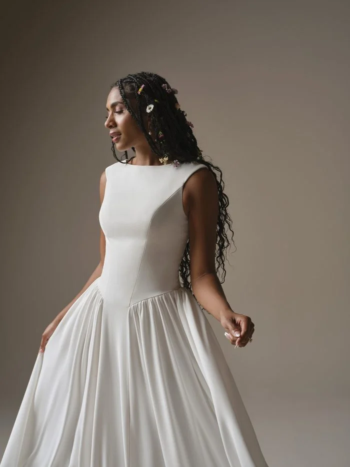 Rebecca Ingram Shay A-line wedding dress with a bateau neckline, fitted bodice, and soft flowing skirt for a lengthening silhouette.