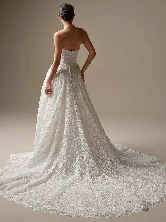 Back view of the Sottero and Midgley Tamar A-line wedding gown with allover lace, covered buttons, and a sweeping lace train