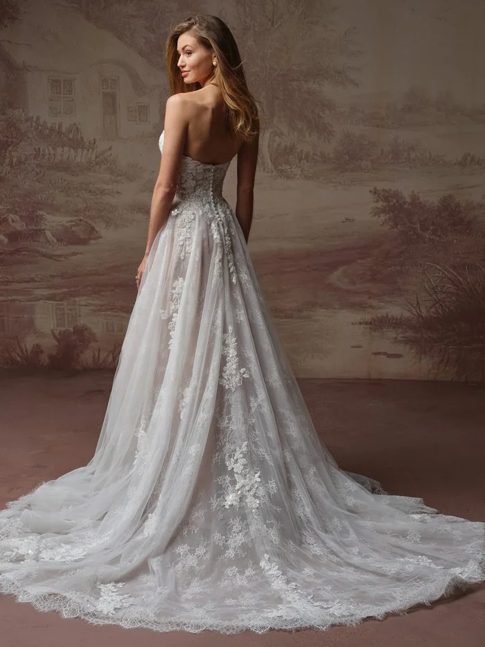 Back view of the Maggie Sottero Hadley A-line wedding gown with floral lace detailing, covered buttons, and a flowing lace-edged train.