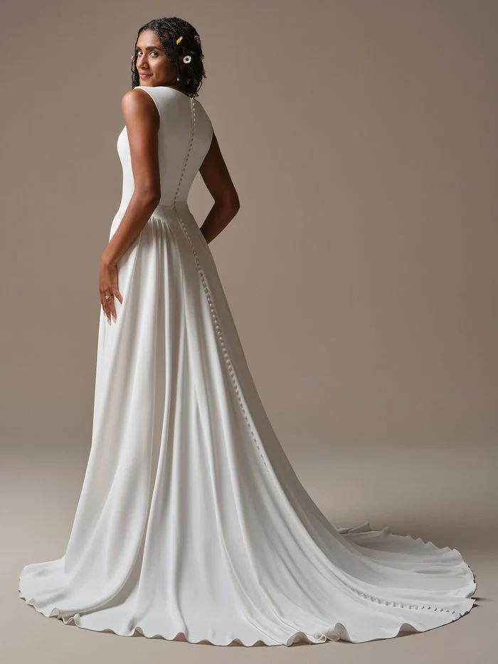Back view of the Rebecca Ingram Shay A-line wedding gown featuring covered buttons and a flowing train, ideal for petite brides.