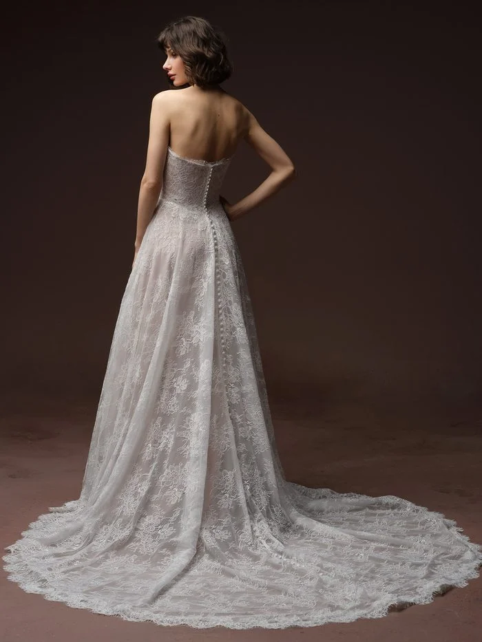 Back view of the Maggie Sottero Maelle A-line wedding gown with a lace-covered bodice, covered buttons, and a sweeping lace train