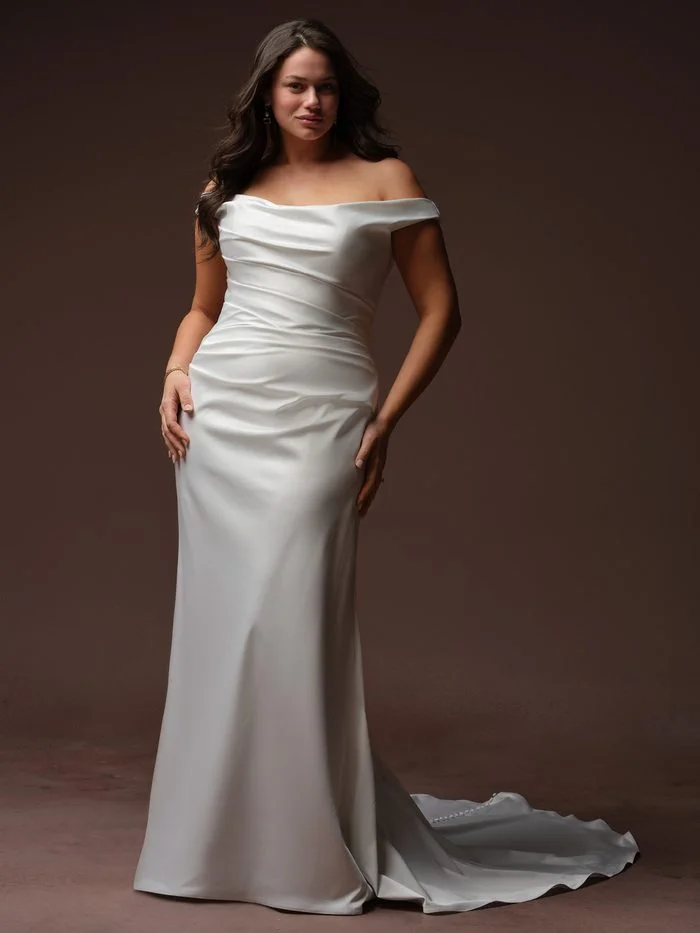 Rebecca Ingram Clementine sheath wedding gown with an off-the-shoulder neckline, soft draping, and a streamlined silhouette that flatters petite brides.