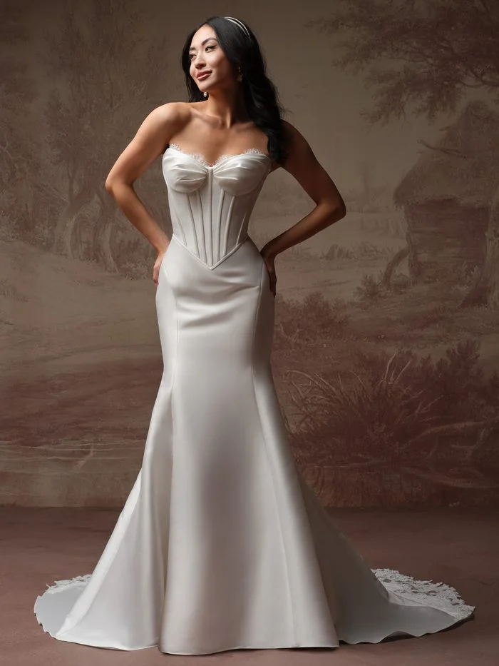 Rebecca Ingram Zorina Lane fit-and-flare wedding gown featuring a corset-inspired bodice, strapless neckline, and sleek silhouette that flatters petite brides.