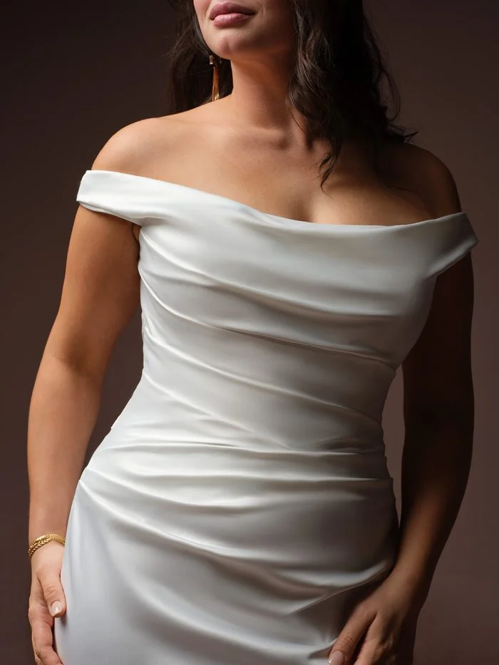 Close up of Rebecca Ingram's Clementine dress Romantic asymmetrically draped off-the-shoulder wedding dress