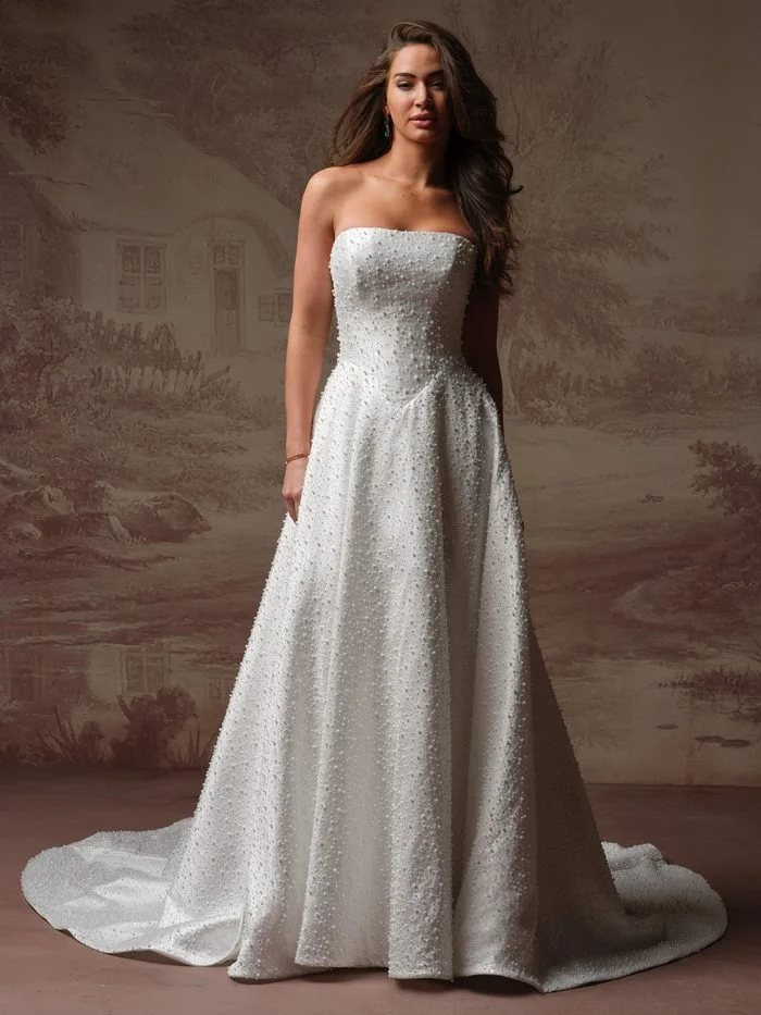 Elowyn by Maggie Sottero A-line wedding dress with a strapless pearl-beaded bodice and full skirt.