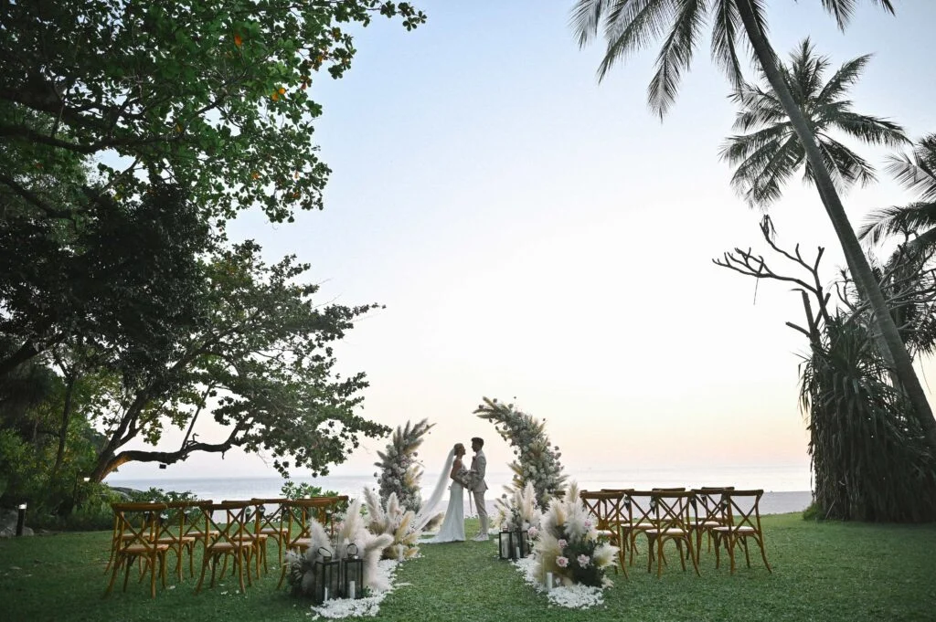 Le Méridien Phuket Beach Resort - garden wedding setup with a view of the beach in the background