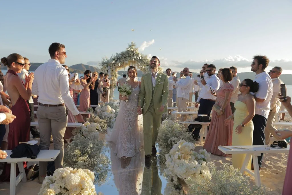 caitline-and-lucas-beach-wedding-at-discovery-coron-philippines-walking-out-of-the-altar-showered-by-flower-petal-confeti