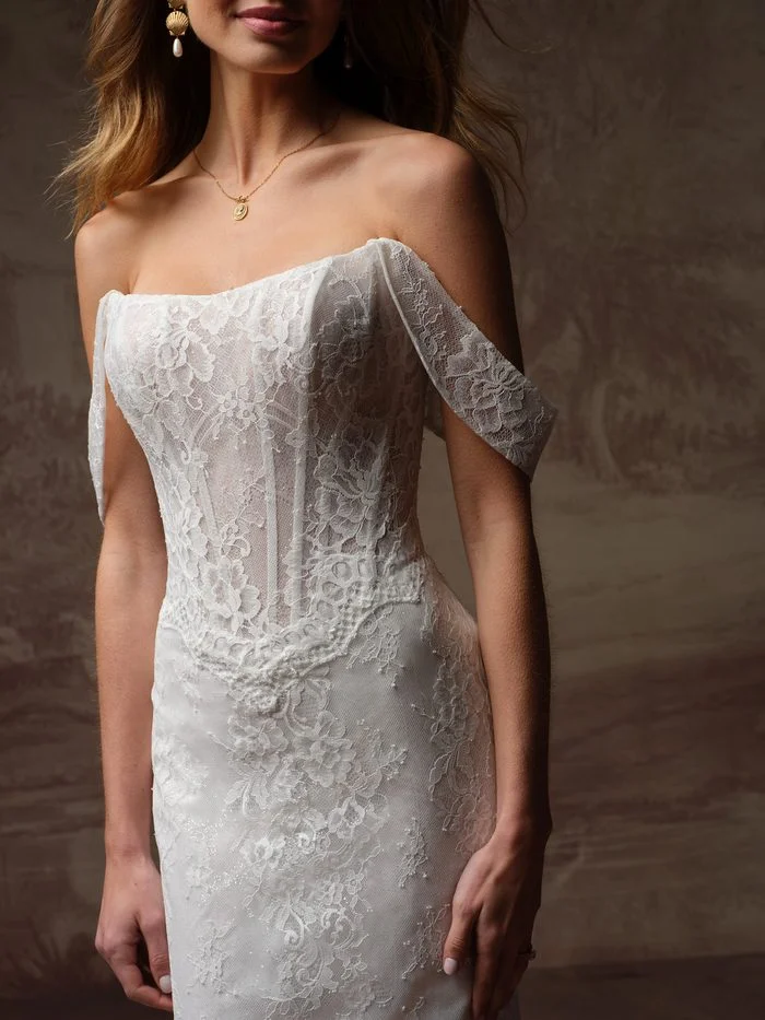 Samira fit-and-flare wedding dress with detachable off-the-shoulder lace sleeves, featuring a sheer corset bodice, floral lace appliqués, and a romantic boho-inspired silhouette.