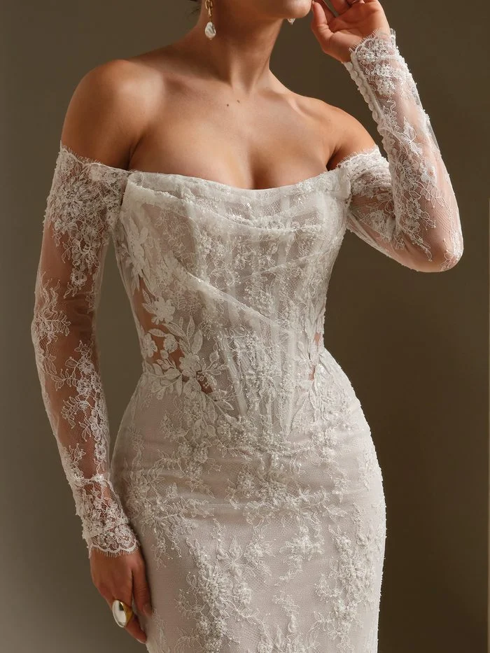 Dublin fit-and-flare wedding dress with detachable lace sleeves, featuring sheer floral lace long sleeves, an off-the-shoulder neckline, and intricate beaded embroidery for a romantic boho bridal look.