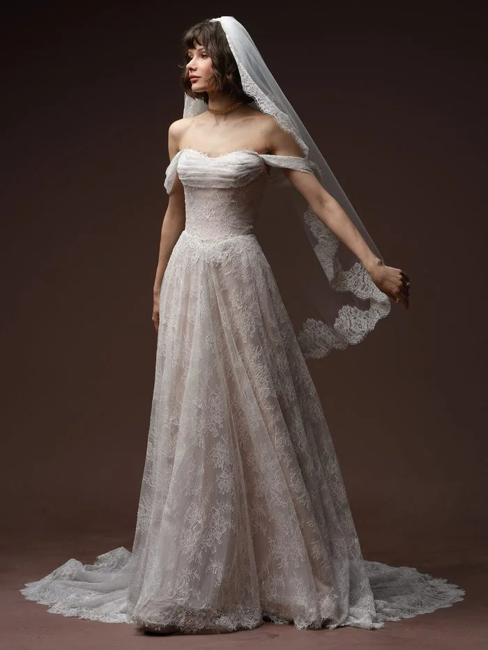 Maelle boho floral wedding dress paired with the Minuet veil, featuring floral lace trim, sheer tulle, and a romantic cathedral-length silhouette for an ethereal bridal look.