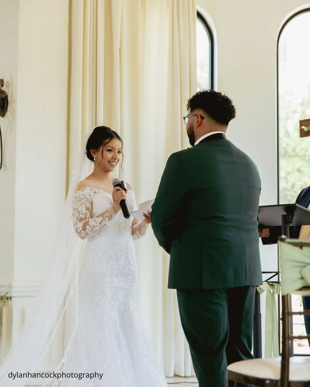 a bride recites her vows to the groom using a microphone dylanhancockphotography