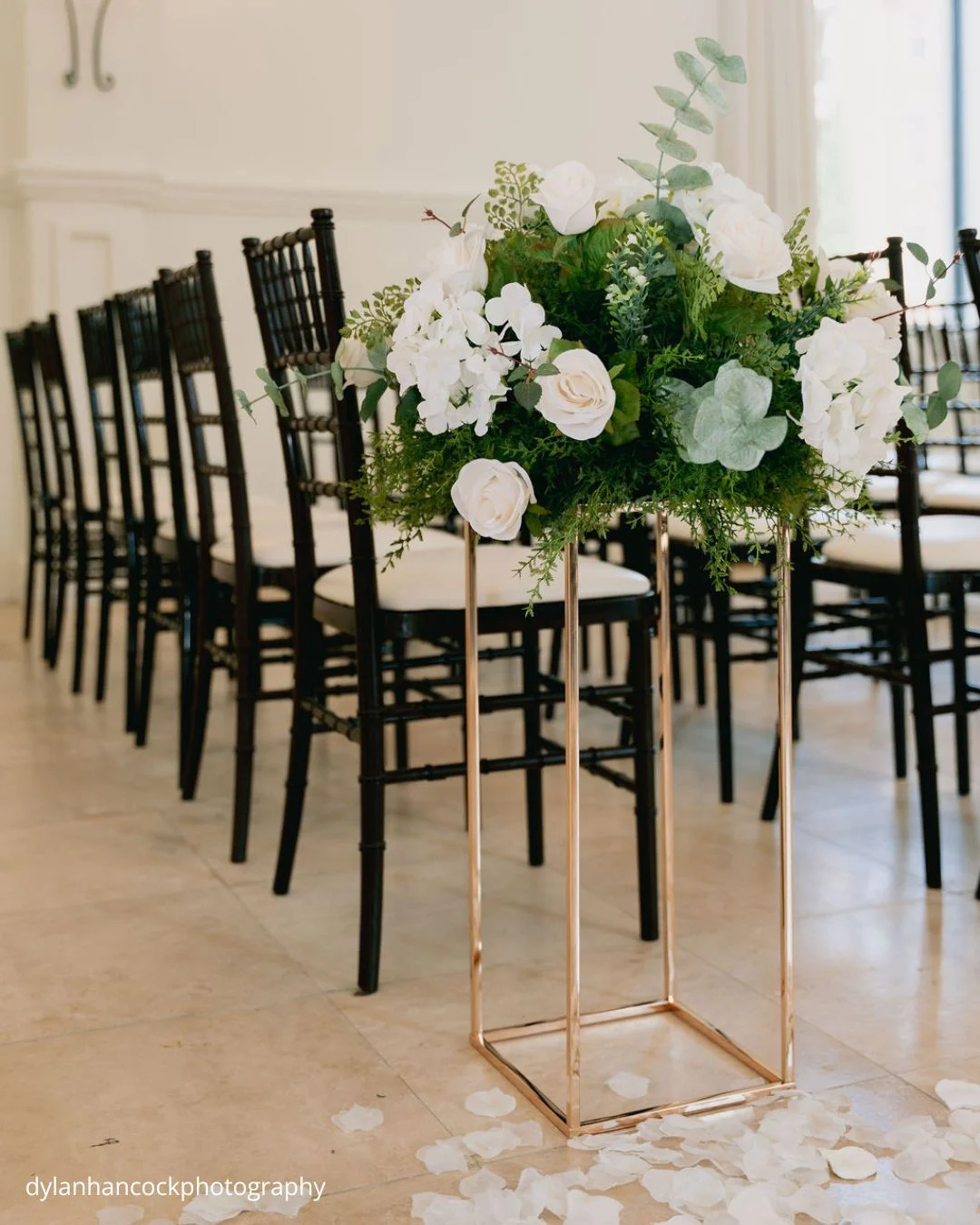 wedding ceremony floral centerpiece on gold pedestal dylanhancockphotography
