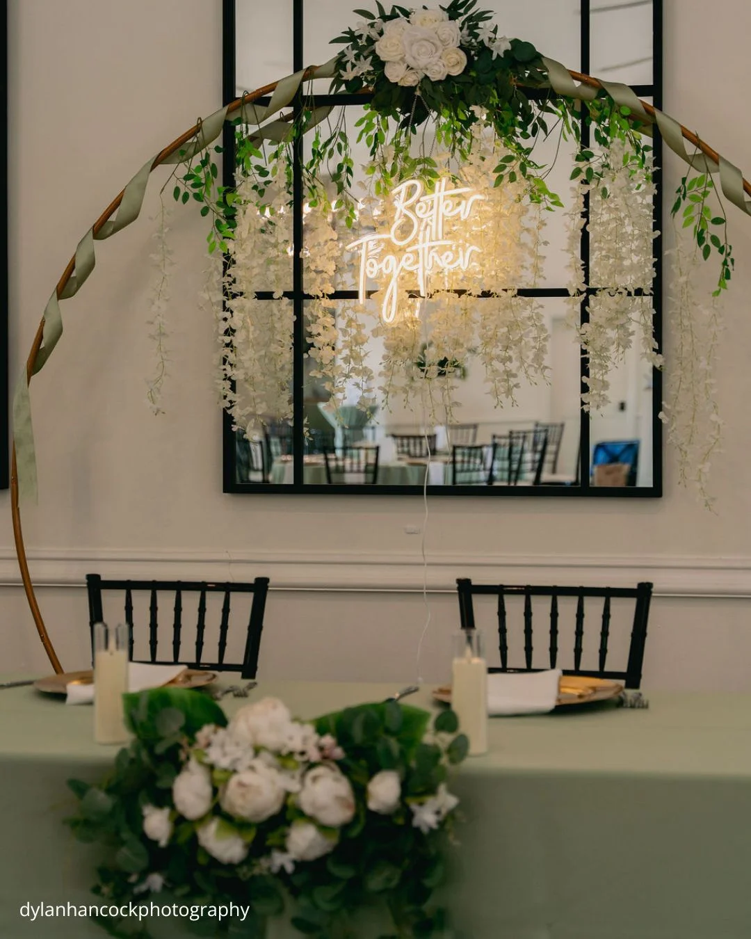 romantic wedding table setup with floral centerpiece and neon sign dylanhancockphotography
