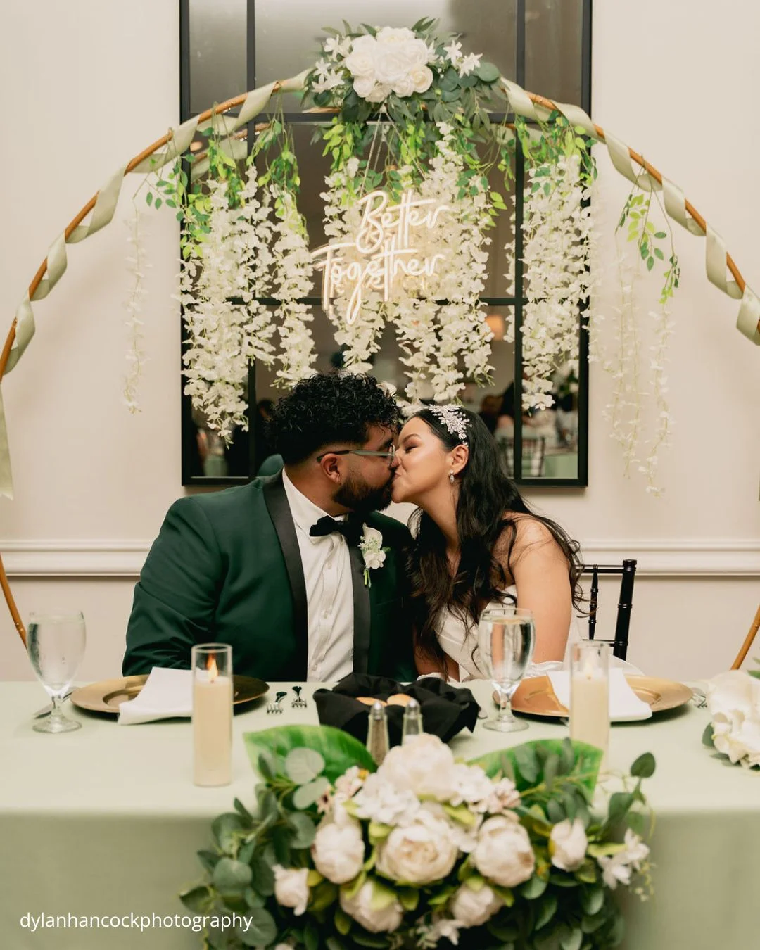 bride and groom share a kiss at wedding reception dylanhancockphotography