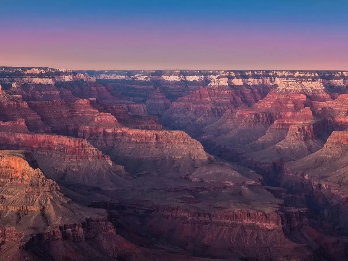 Layered red canyon walls of the Grand Canyon glowing at sunset