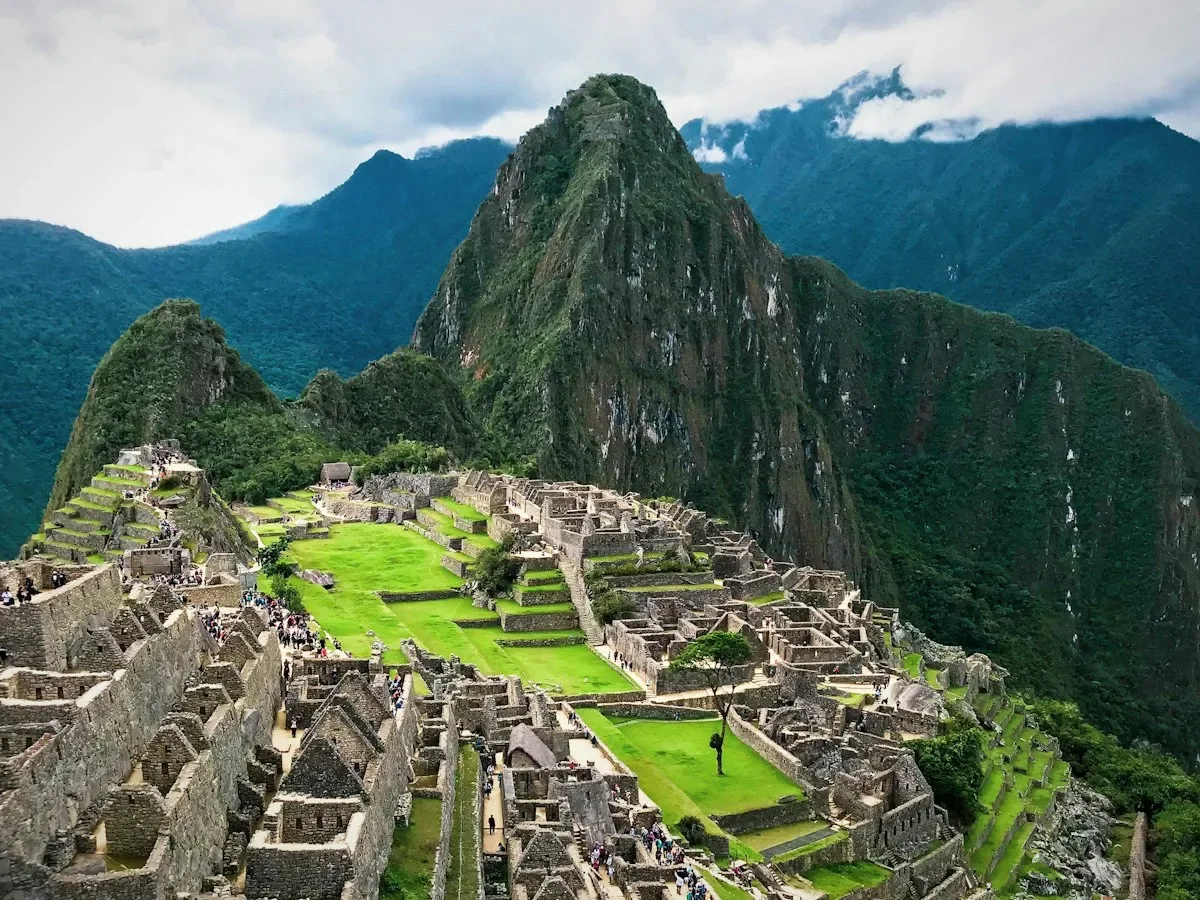 The stone ruins and green terraces of Machu Picchu below Huayna Picchu in Peru